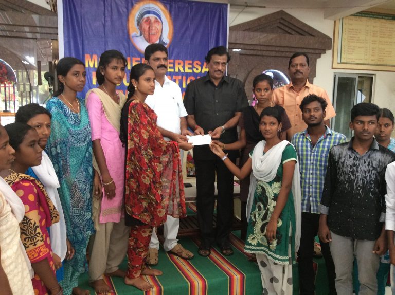 Chief guest handing over cheque on behalf of Foundation