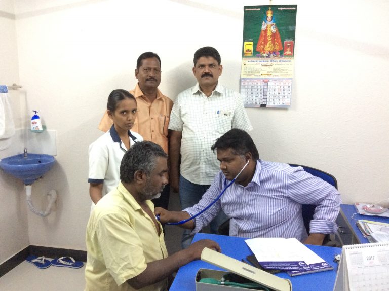 Dr. Anbumani, Diabetologist examining the patient in the medical camp.