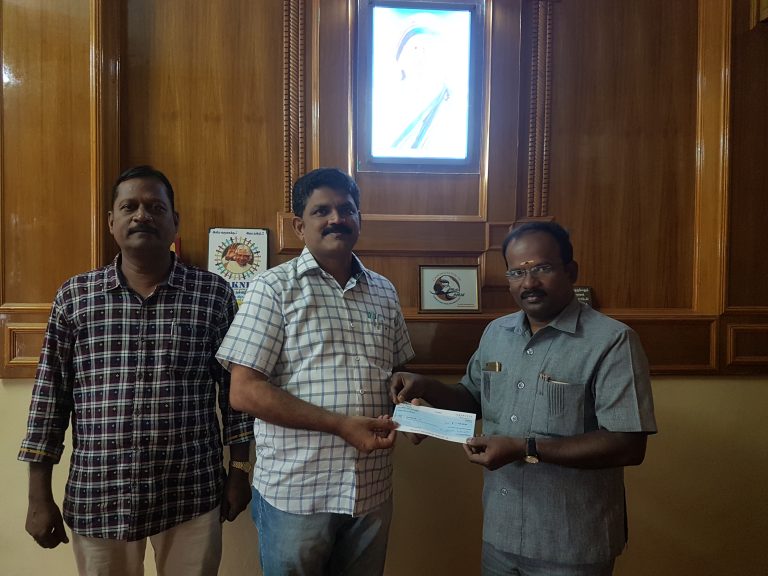 Chairman receiving cheque from Mr. Dhanapal