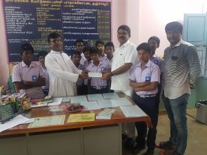 Chairman handing over cheque to Headmaster
