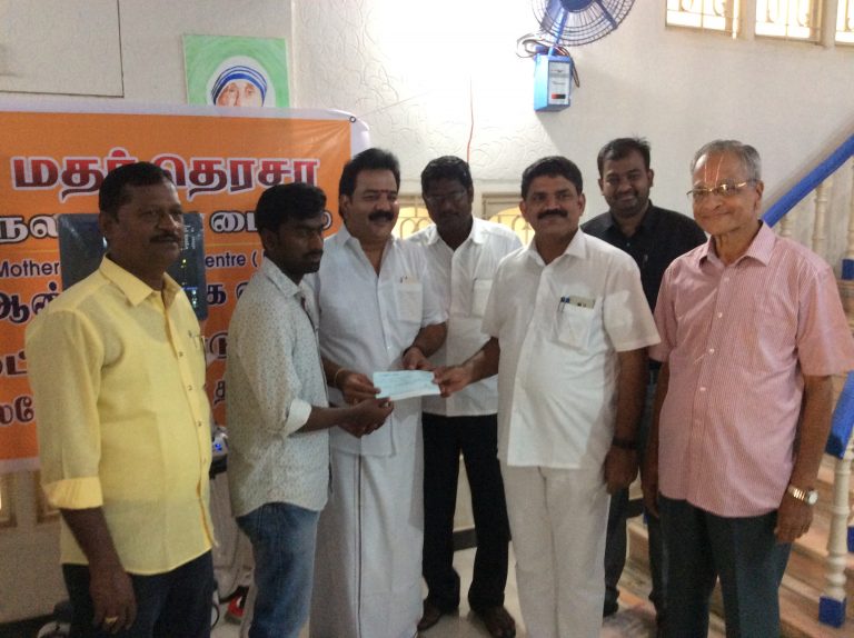 Selvan. D. Prasanth receiving cheque from chief guest