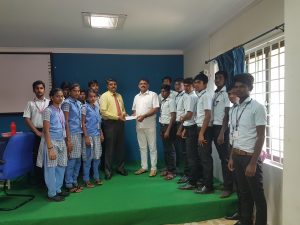 Chairman Handing over cheque to Principal