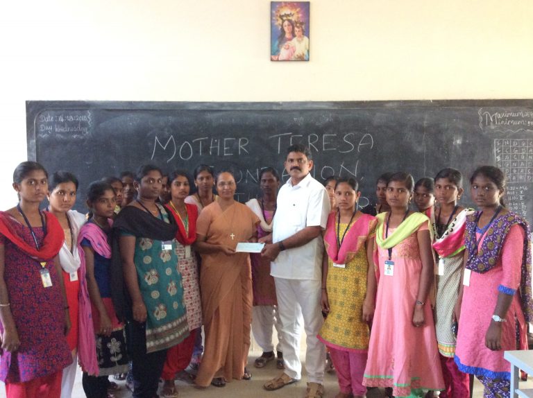 Chairman handing over cheque to Rev. Sr. Principal